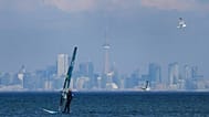 A windsurfer cuts through the waves along Lake Ontario overlooking the City of Toronto in Mississauga, 9 February, 2024