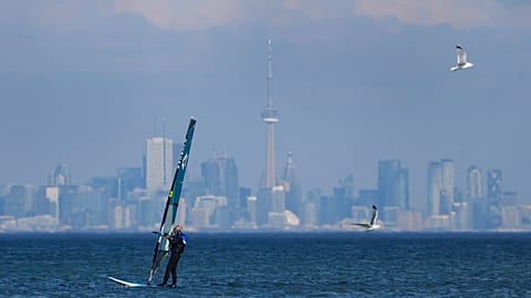 A windsurfer cuts through the waves along Lake Ontario overlooking the City of Toronto in Mississauga, 9 February, 2024