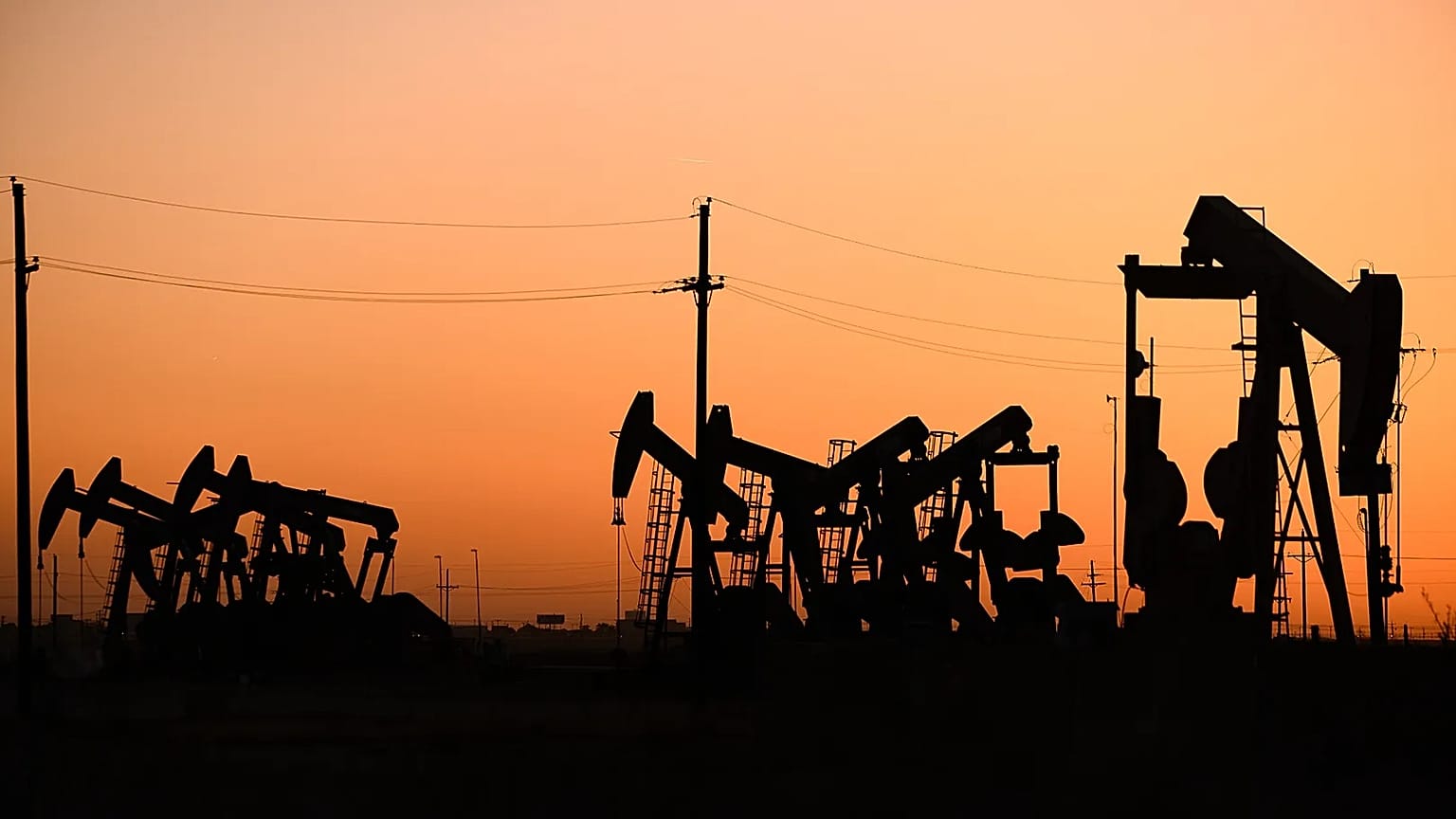 An array of pumpjacks operate near the site of a new oil and gas well in Midland, Texas.