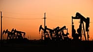 An array of pumpjacks operate near the site of a new oil and gas well in Midland, Texas.