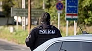 A Slovak police officer stands at the Hungarian-Slovakian border crossing point between Somoskoujfalu, Hungary, and Satorska Bukovinka, southern Slovakia.