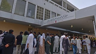 People gather outside a nursery in the gynaecology ward following a fire at a hospital in Islamabad, 26 August, 2026