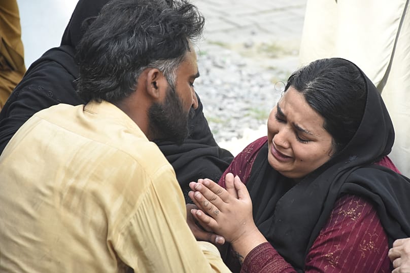 Parents react after their child died in a hospital fire in Islamabad, 26 August, 2026