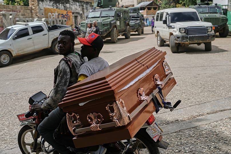Men transport an empty coffin on a motorcycle in the Kenscoff neighborhood of Port-au-Prince., Haiti, Tuesday, 25 Aug, 2026. 