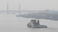 A tug boat cruises on Musi River as haze from wildfires blankets the city of Palembang, 25 August, 2026