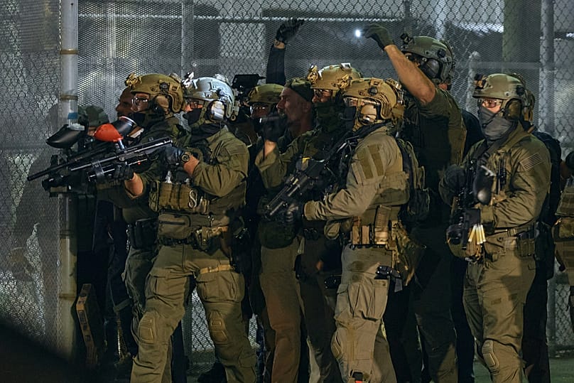 ICE agents aim at protesters outside the Delaney Hall detention center during a protest against the transfer of detainees in Newark, 29 May, 2026