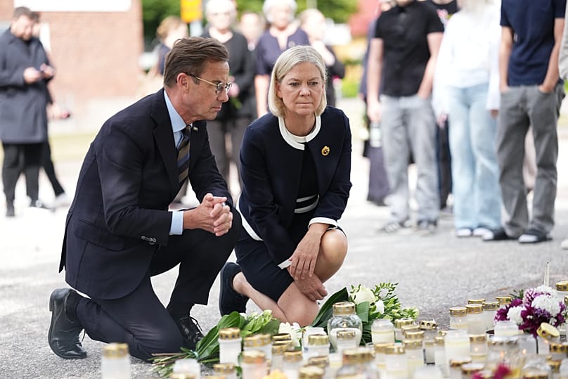 Sweden's Prime Minister Ulf Kristersson, left, and Social Democratic Party leader Magdalena Andersson visit the memorial. 22 August, 2026.