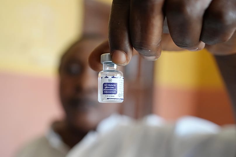 A health worker shows a bottle of the malaria vaccine R21/Matrix-M before administering it in Yenagoa, 9 December, 2024