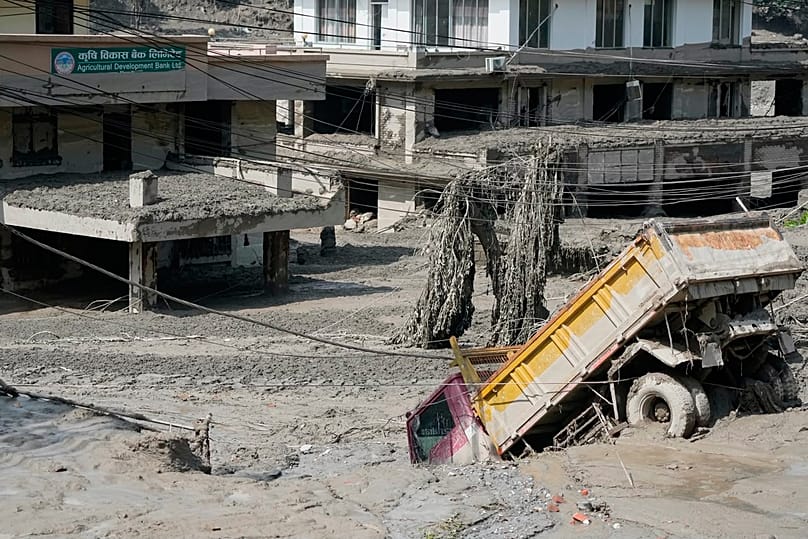 Damaged houses and vehicles are seen in the aftermath of flash floods along the Trishuli River in the Nuwakot district, 26 August, 2026