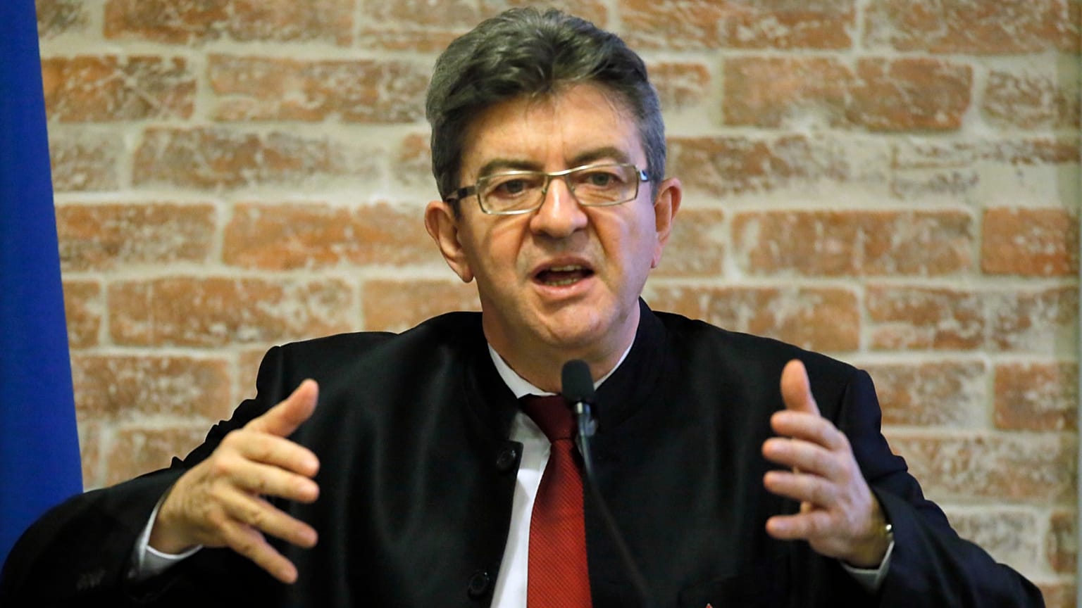French left wing leader Jean-Luc Melenchon delivers a speech during a meeting on defense in Paris, Friday, March 31, 2017.  