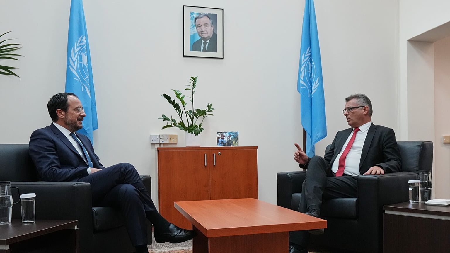 Cyprus' President Nikos Christodoulides and Turkish Cypriot leader Tufan Erhürman talk during their meeting at a UN compound in the Nicosia airport area, 26 August, 2026