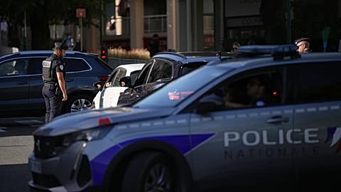 A French police officer is checking vehicles.