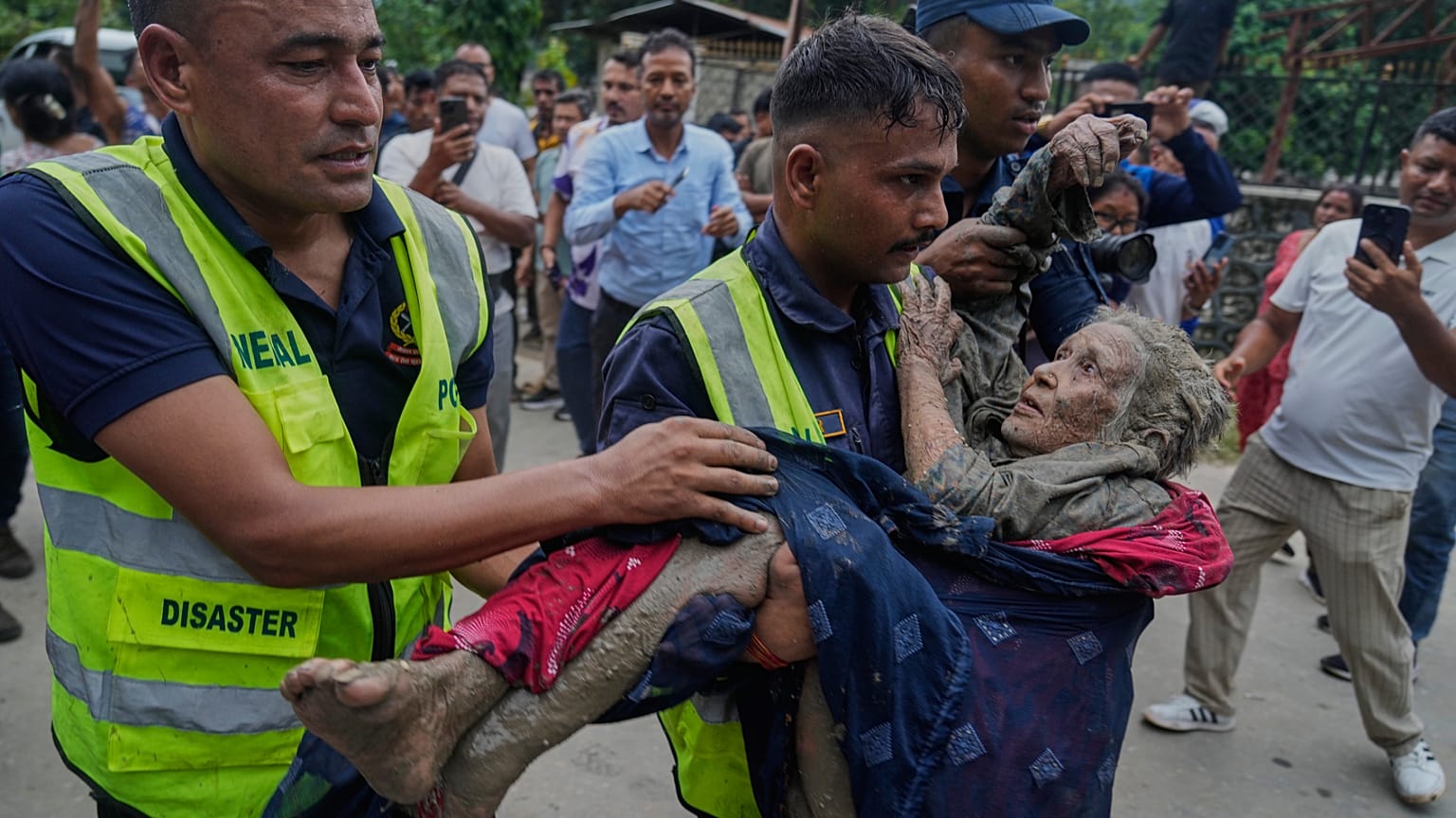 Rescuers carry a victim of the floods.