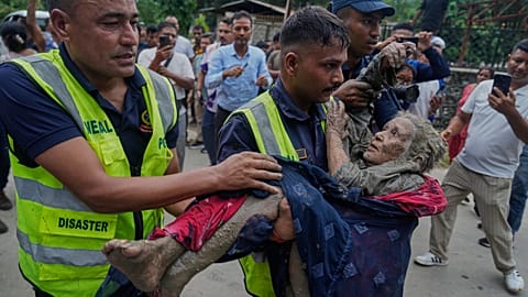 Rescuers carry a victim of the floods.