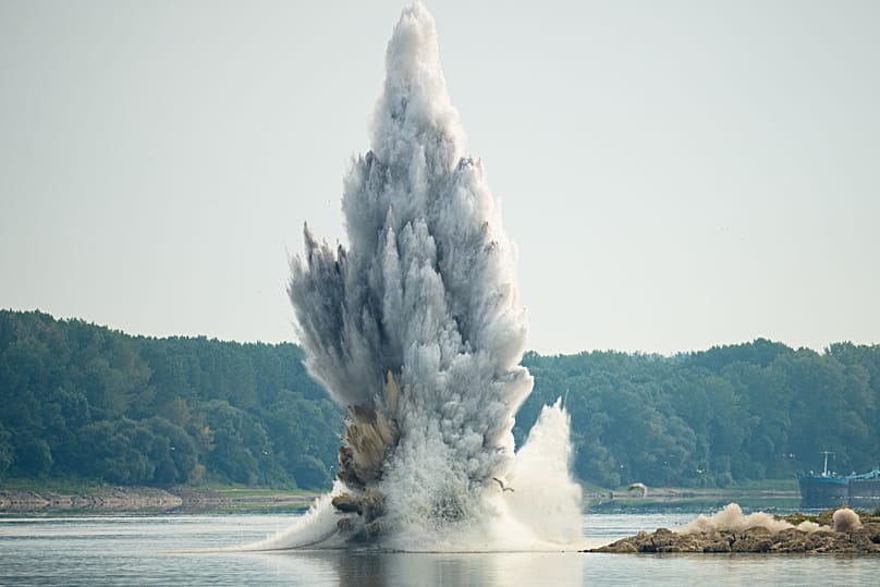 The Romanian Navy detonates underwater explosives during a controlled demolition of submerged rocks to improve water flow to the Cernavoda Nuclear Power Plant, 3 August.