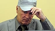 FILE - Former Bosnian Serb Gen. Ratko Mladic removes his hat in the court room during his initial appearance at the U.N.'s Yugoslav war crimes tribunal in The Hague, 3 June 20