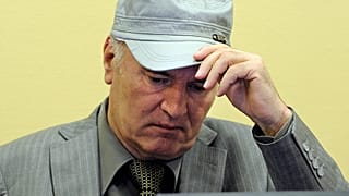 FILE - Former Bosnian Serb Gen. Ratko Mladic removes his hat in the court room during his initial appearance at the U.N.'s Yugoslav war crimes tribunal in The Hague, 3 June 20