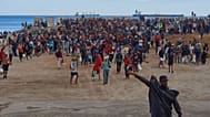 مهاجرون عبروا من المغرب إلى إسبانيا يعودون إلى شاطئ في جيب سبتة الإسباني، بعد طردهم من المنطقة في اليوم السابق، يوم الجمعة 21 أغسطس/آب 2026. (صورة من وكالة أسوشيتد برس/أنطونيو