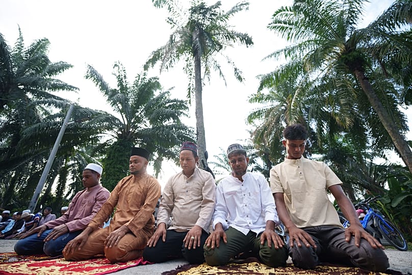 Rohingya Muslims perform morning prayer marking the Eid al-Adha outside a mosque in Klang, 27 May, 2026