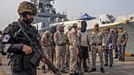 A police officer stands guard as Mumbai Police takes charge of accused Somali pirates in Mumbai, 23 March, 2024