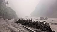 Muddy river bank with debris is seen near Gyirong Por
