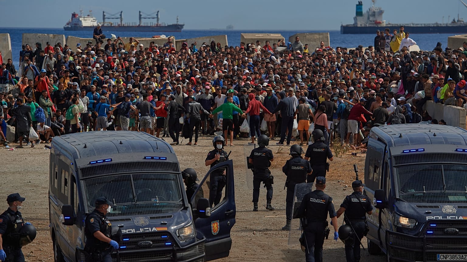 Migrants who crossed from Morocco into Spain return to a beach after being expelled from the area the previous day, 21 August, 2026