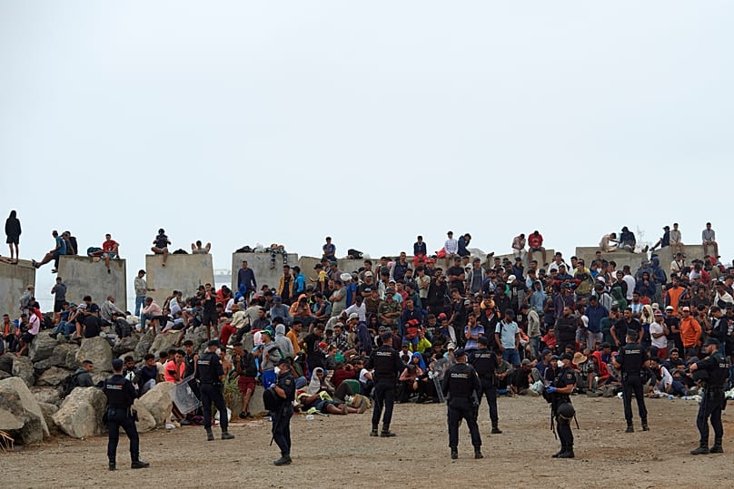 Migrants who crossed from Morocco into Spain return to a beach after being expelled from the area the previous day, 21 August, 2026