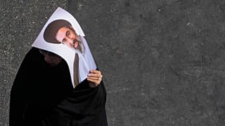 An Iranian woman carries a poster of the Supreme Leader Ayatollah Mojtaba Khamenei