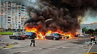 Cars burn as firefighters try to put out a fire following a Russian drone attack in Kyiv region, 28 August, 2026