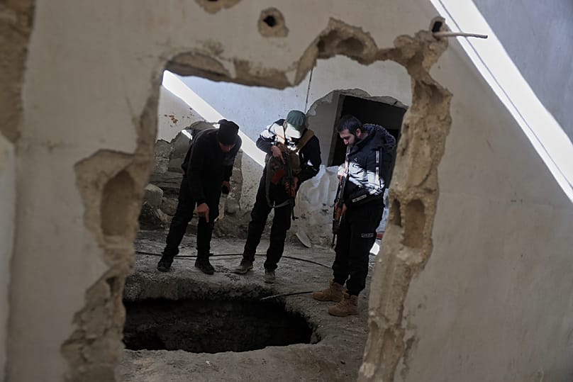 FILE: Syrian government security forces inspect tunnels used by the retreating Syrian Democratic Forces (SDF) in Raqqa, 20 January 2026