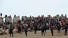 Migrants who crossed from Morocco into Spain return to a beach after being expelled from the area the previous day, 21 August, 2026