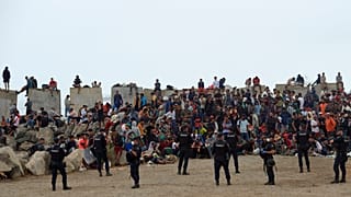 Migrants who crossed from Morocco into Spain return to a beach after being expelled from the area the previous day, 21 August, 2026