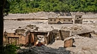Damaged houses are seen along the river Trishuli following flash floods in Nepal's Nuwakot district, Saturday, Aug. 29, 2026.