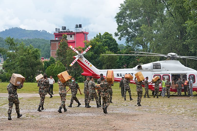 Nepalese army soldiers load relief supplies onto a helicopter for survivors stranded in areas cut off by flash flooding in Nepal's Nuwakot district, Saturday, Aug. 29, 2026.