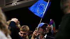 A supporter waves a European Union flag during an election-night gathering for the yes in Reykjavik, Iceland, Sunday, Aug. 30, 2026.