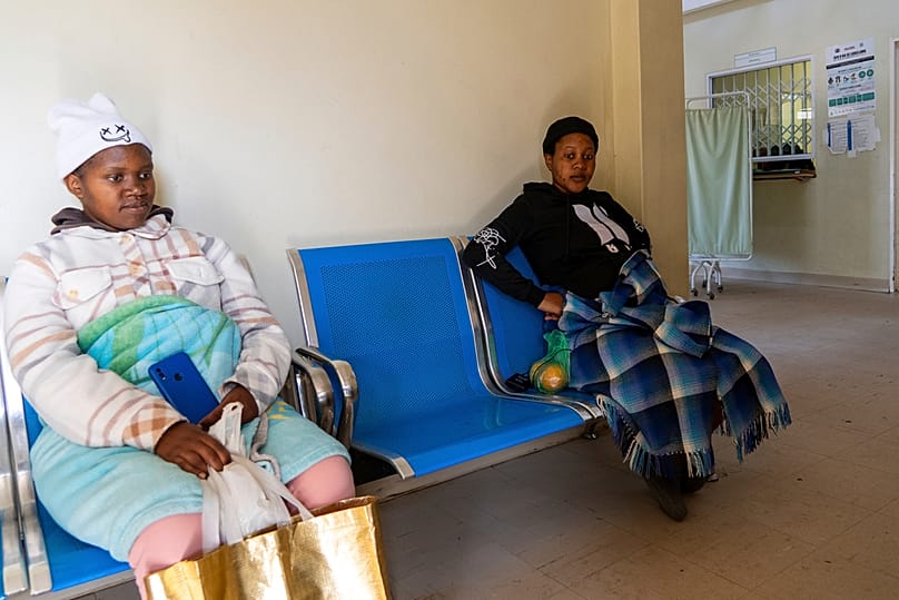 Expectant mothers Bonolo Tebelo, left, and Mpolokeng Mafereka wait for their appointments at Mpharane Health Centre in Mohale's Hoek district, Lesotho, Friday, July 10, 2026.