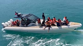 Rescued passengers wearing life jackets are evacuated by boat after a passenger vessel capsized off the coast of Girne, 30 August, 2026