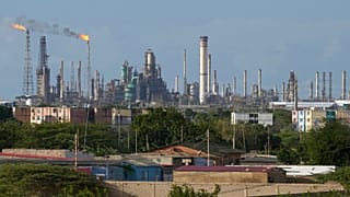 FILE - Flames rise from flare stacks at the Amuay refinery in Los Taques, Venezuela, Jan. 14, 2026. 