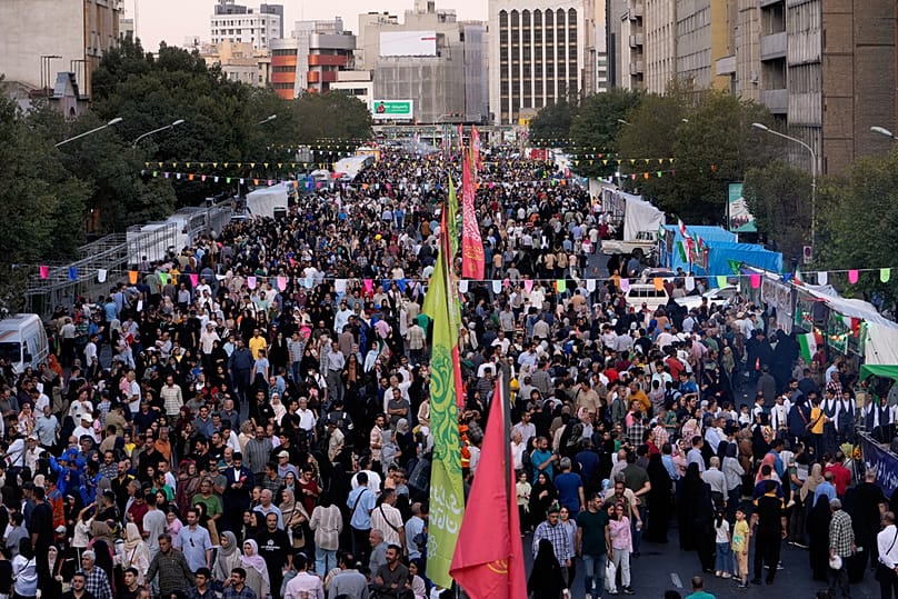 Crowds fill a street during celebrations marking Prophet Muhammad's birthday in Tehran, Iran, Sunday, 30 August, 2026
