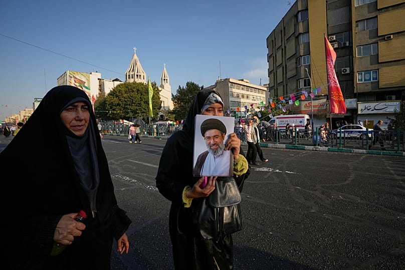 A government supporter holds portrait of Iran's Supreme Leader Mojtaba Khamenei during a street celebration in Tehran, Iran, Sunday, 30 August, 2026
