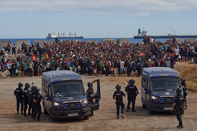 Migrants who crossed from Morocco into Spain return to a beach after being expelled from the area the previous day, 21 August, 2026