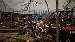 Destroyed vehicles and debris are scattered the day after a Russian attack struck a warehouse in the village of Myla, 30 August, 2026