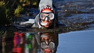 A competitor takes part in the World Bog Snorkelling Championships at Waen Rhydd peat bog in Llanwrtyd Wells, Wales.