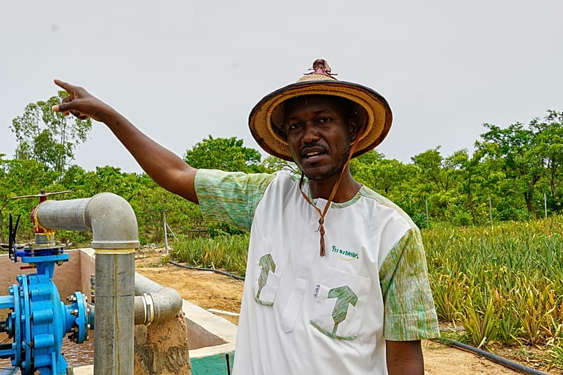 Farmer Oumarou Compaoré speaks to the Associated Press as he stands by one of the irrigation systems at Djoda Farm in Matourkou, near Bobo-Dioulasso, Burkina Faso, May 7, 2026