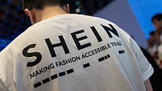 FILE - A logo of fast-fashion online retailer Shein is seen on the t-shirt at the listing ceremony in Hong Kong, Tuesday, Sept. 1, 2026. (AP Photo/Chan Long Hei)