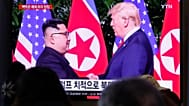 People watch a TV screen showing a file image of North Korean leader Kim Jong-un and US President Donald Trump at Seoul Railway Station, 1 January, 2020 