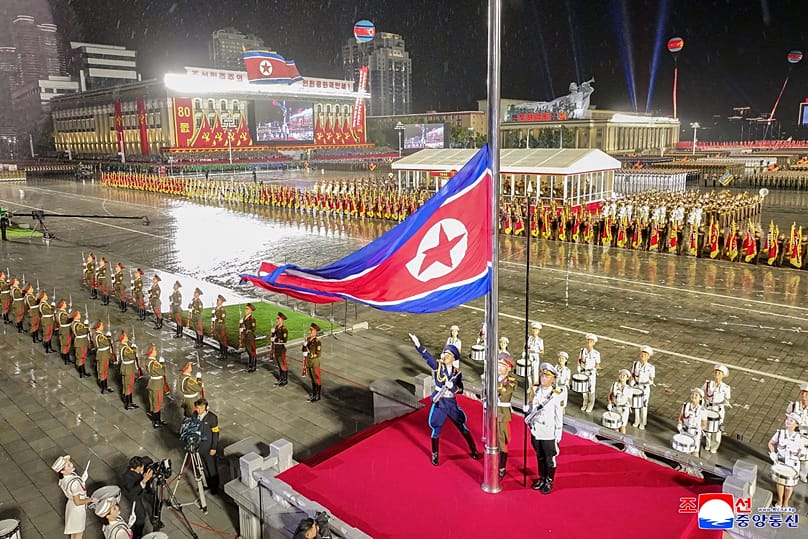 A North Korean flag is raised during a military parade marking the 80th anniversary of the founding of the ruling Worker's Party in Pyongyang, 10 October, 2025