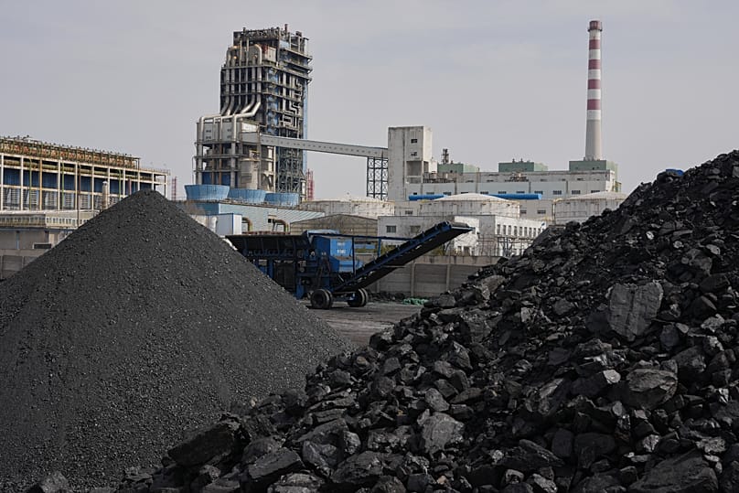 Piles of coal sit near a chemical plant in Datong, 14 March, 2026