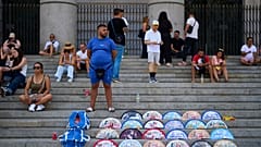 A street vendor sells fans near the Royal Palace in Madrid, Spain