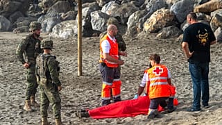 Spanish army soldiers and Red Cross workers assist a migrant who swam from Morocco to the Spanish enclave of Ceuta, Saturday, Aug. 1, 2026.